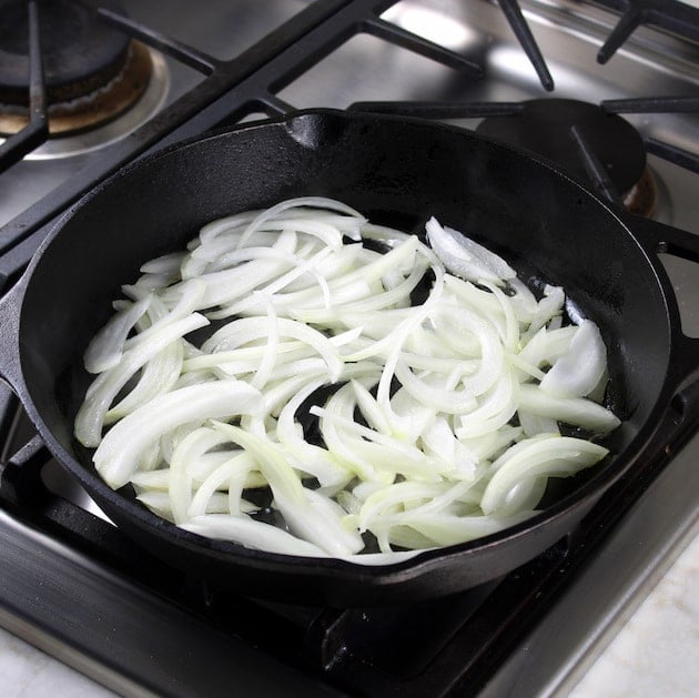 onions cooking in cast iron skillet