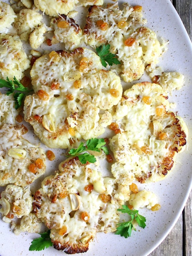 Cauliflower with Asiago Cheese and Golden Raisins and parsley garnish