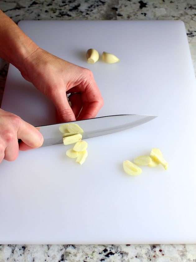 Slicing garlic on cutting board