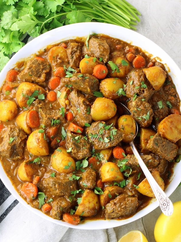 A bowl filled with Indian spiced meat and vegetables.