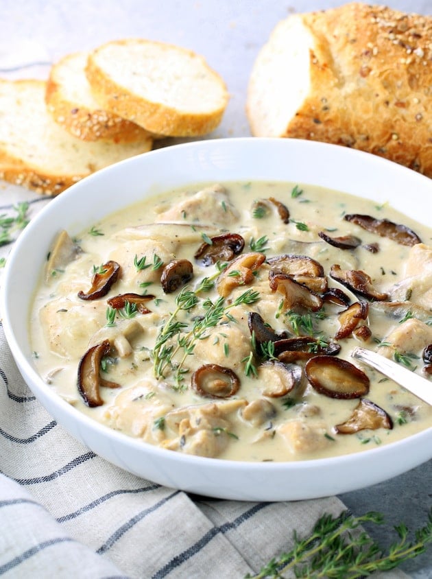 Chicken Mushroom Soup in a bowl with sliced bread