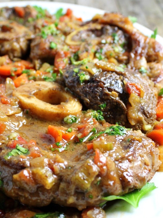 Veal Osso Buco close up eye level photo on a platter 