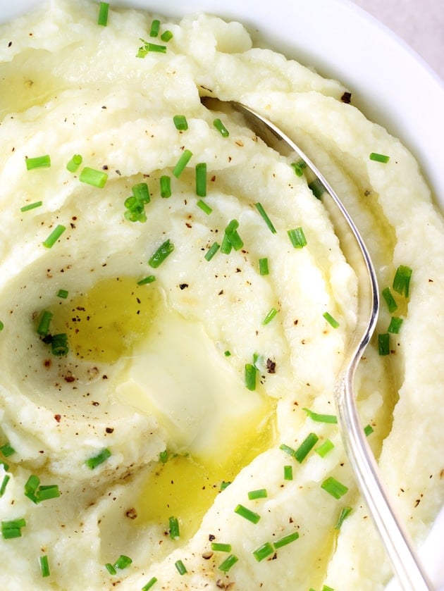 A close up of a Bowl of mashed cauliflower with melted butter