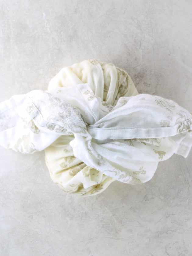 Kitchen cloth wrapped tightly around cooked cauliflower