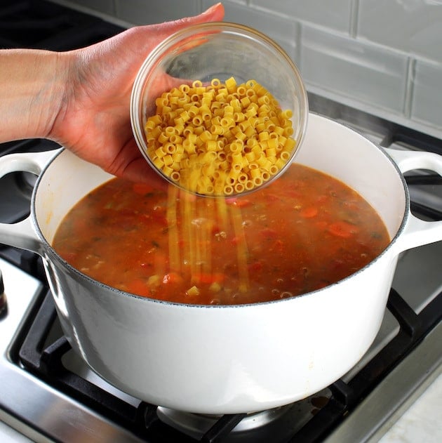 adding pasta to italian soup