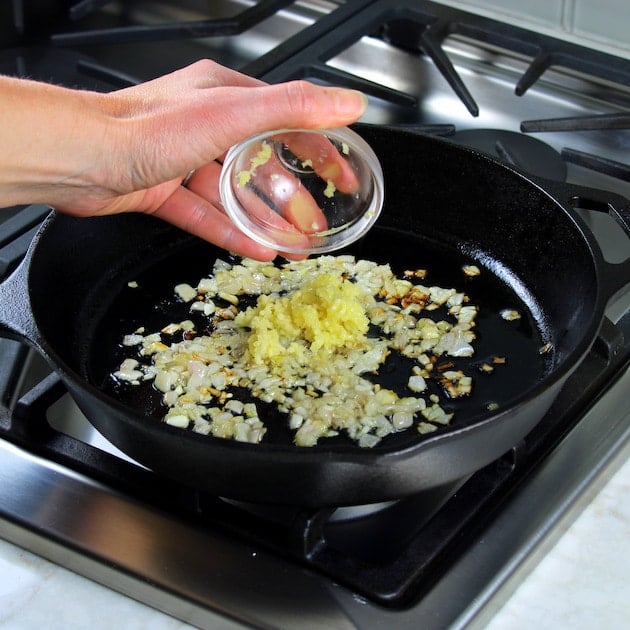 Adding garlic to skillet with onions 