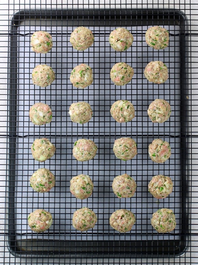 The balls formed and placed on a wire rack above baking sheet before cooking.