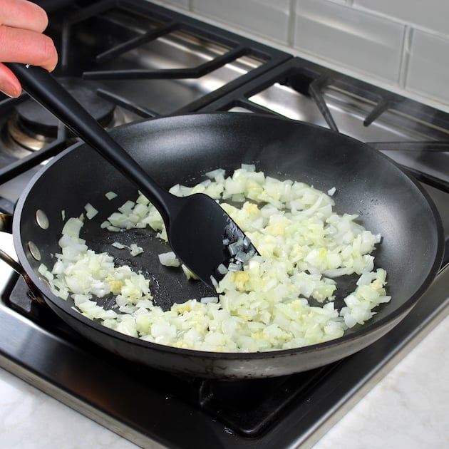 Food cooking in a pan on a stove