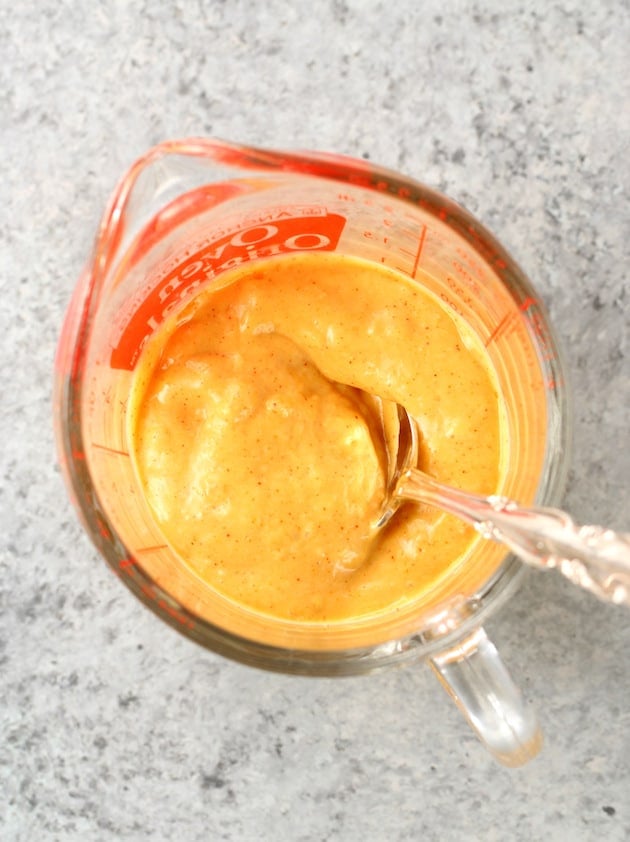 orange sauce in glass measuring cup