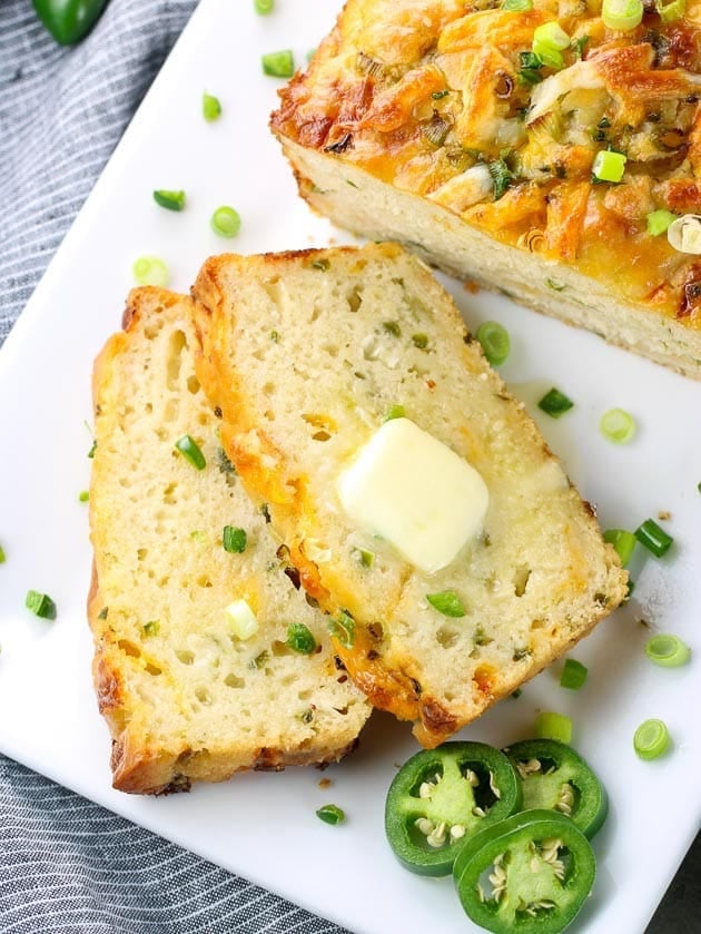 Two slices of Cheesy Jalapeño Beer Bread on a platter.