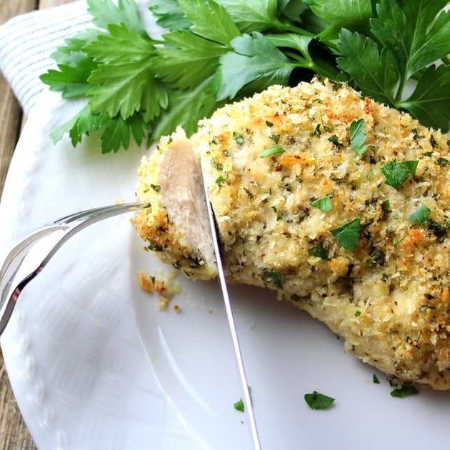 A piece of food on a plate, with Chicken.  The best Parmesan Crusted Chicken Recipe!