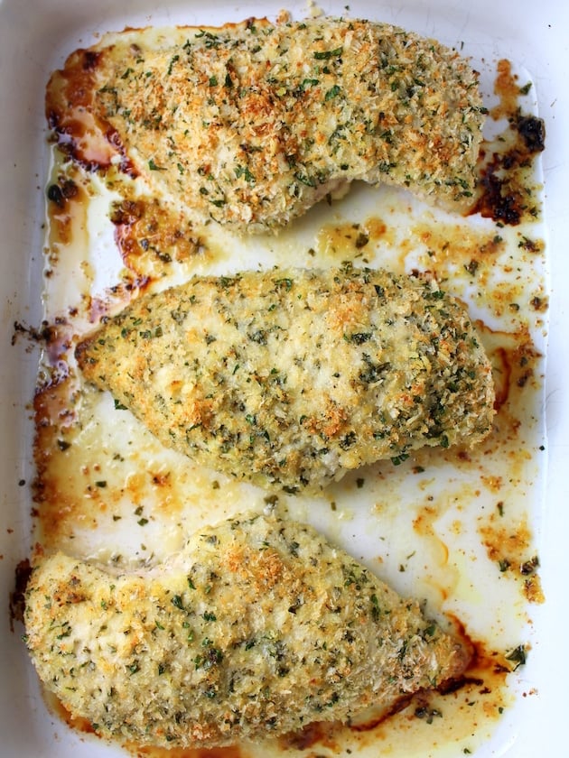 Baked Parmesan Crusted Chicken breasts in a casserole dish