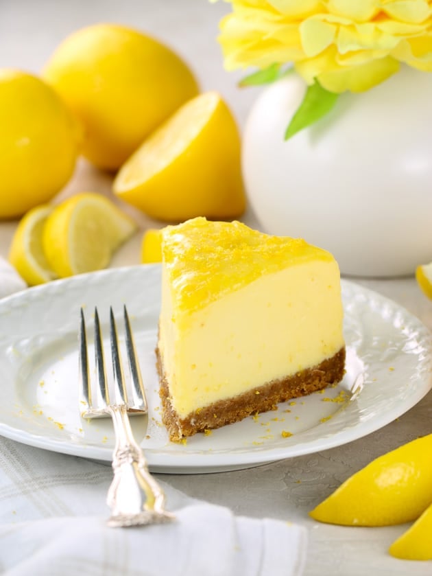 Eye level view of slice of lemon cheesecake on a plate, with fork