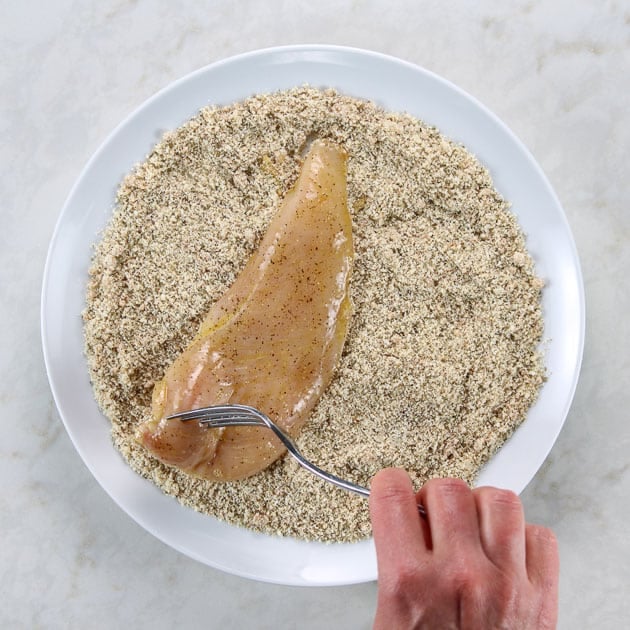 Coating chicken breast with breading mixture