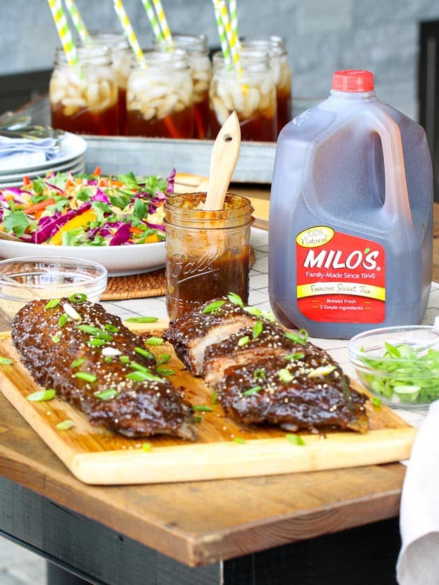 Tablescape with sweet tea, baby back ribs, and asian slaw