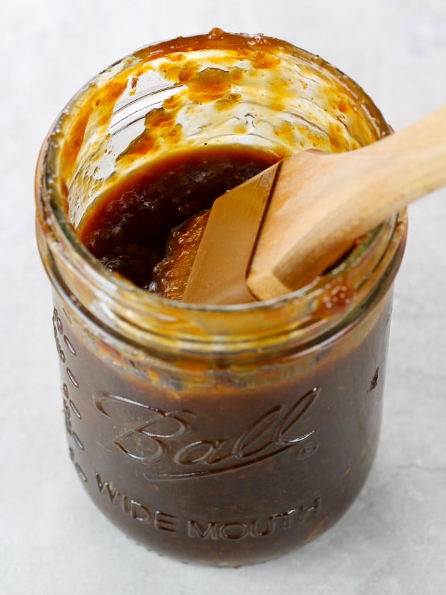Mason jar with bbq sauce and basting brush