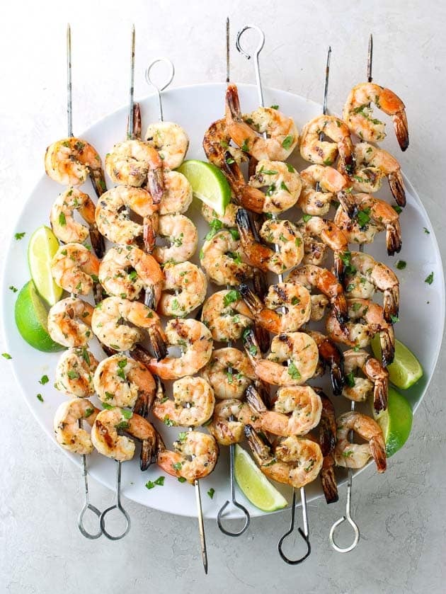 Skewers of grilled shrimp on a platter
