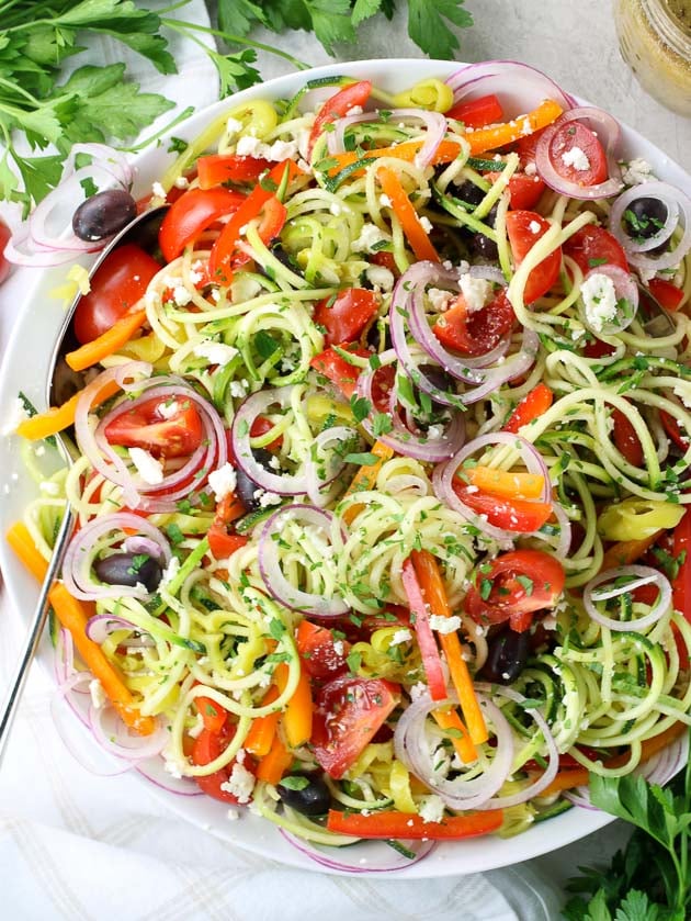 Bright colorful salad with Spiralized vegetable noodles on a large white platter