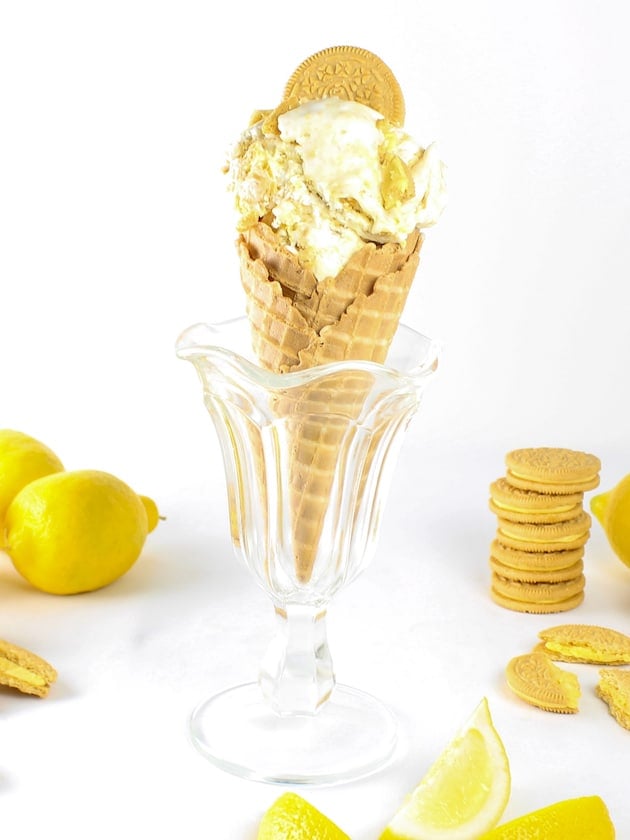 Eye level lemon ice cream cone in a glass sundae dish