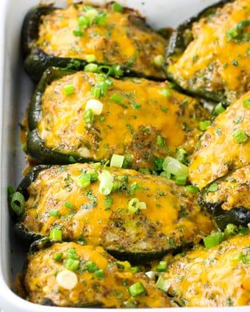 Partial casserole dish of stuffed poblano peppers