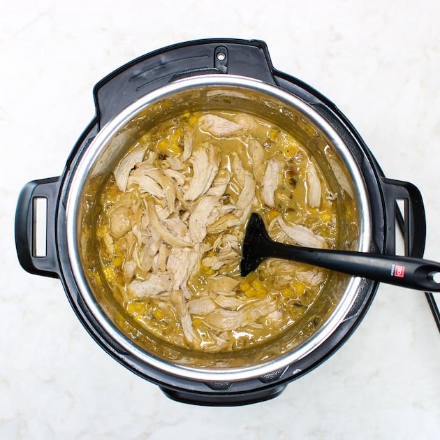 Shredded chicken added back to soup in instant pot with spatula