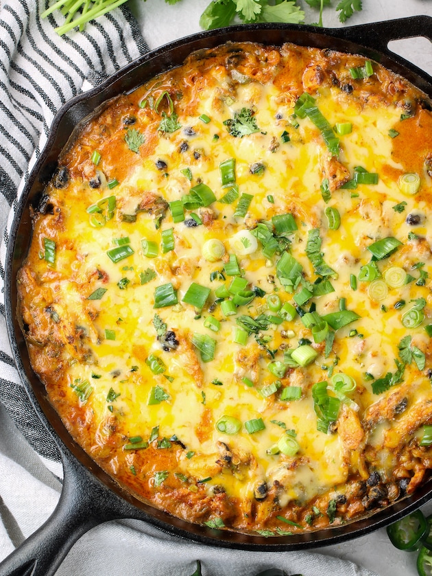 Baked taco dip appetizer in large cast iron skillet.