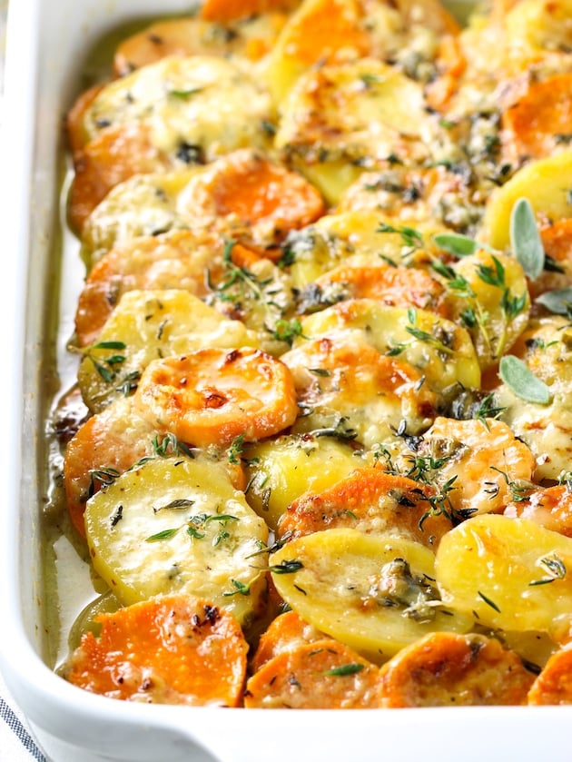 Eye level close up partial dish of scalloped potatoes