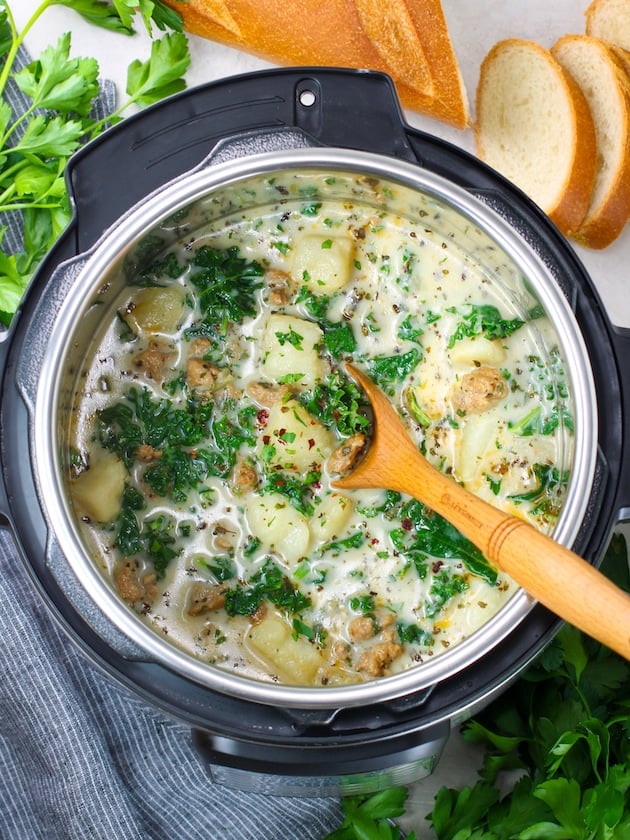 instant pot full of italian sausage soup with kale and potatoes