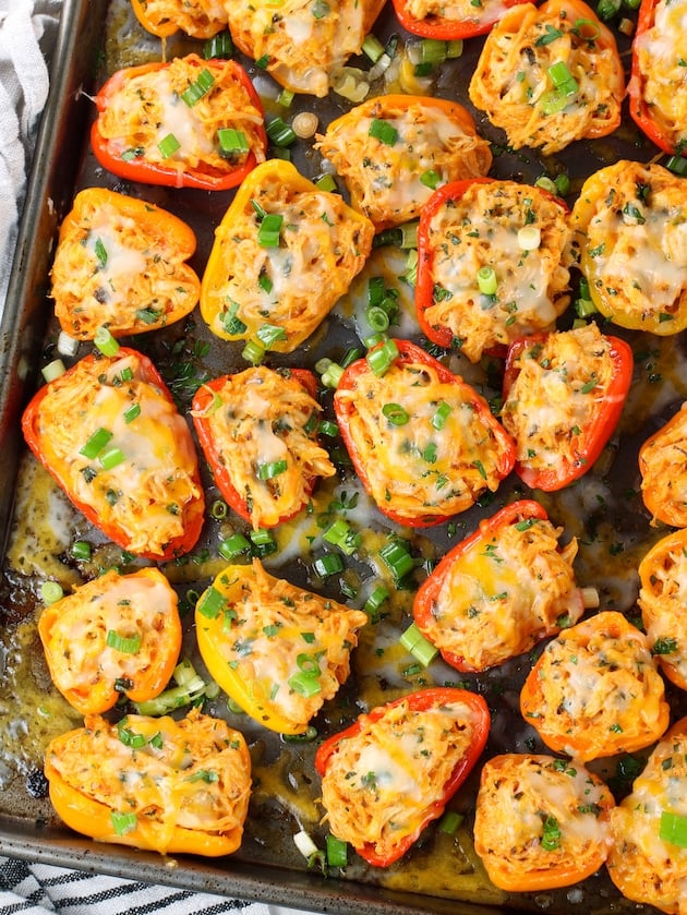 stuffed baby bell peppers on a baking sheet