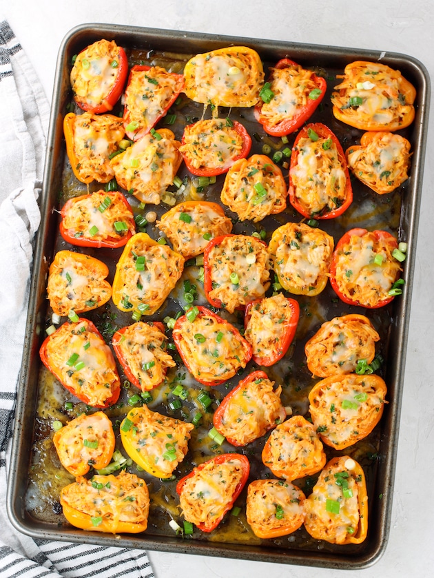 Cookie sheet with Baby Bell Peppers Stuffed with melted cheese