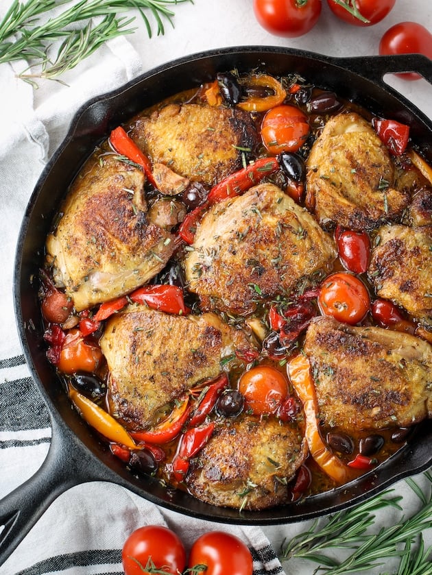 Partial skillet of chicken fricassee with cherry tomatoes and bell peppers