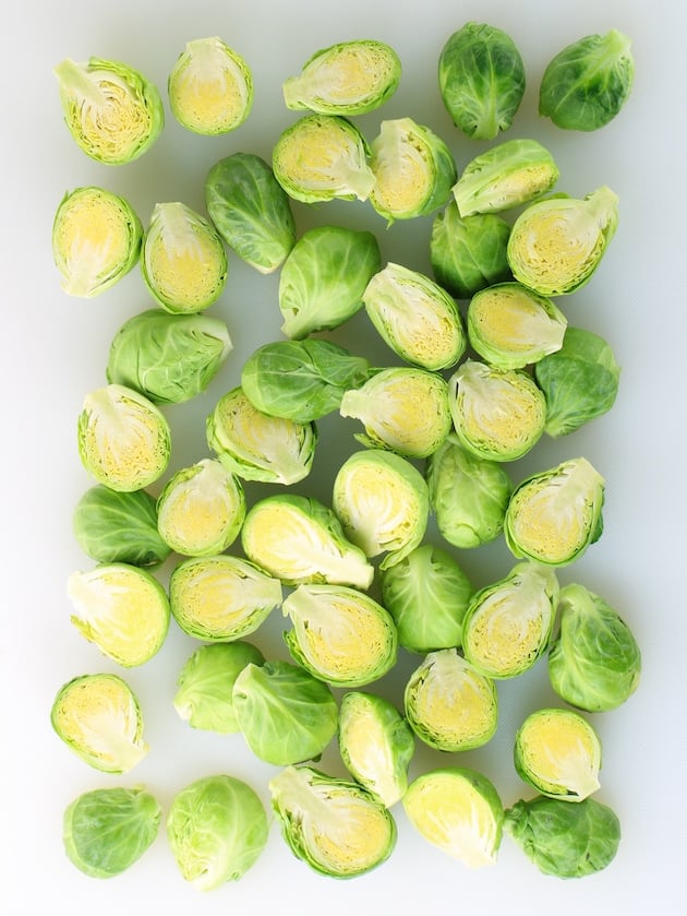 halved Brussels sprouts on a cutting board before cooking