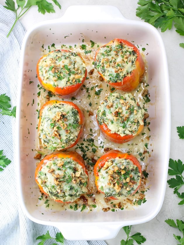 Bell peppers stuffed with chicken Florentine in a baking dish after cooking