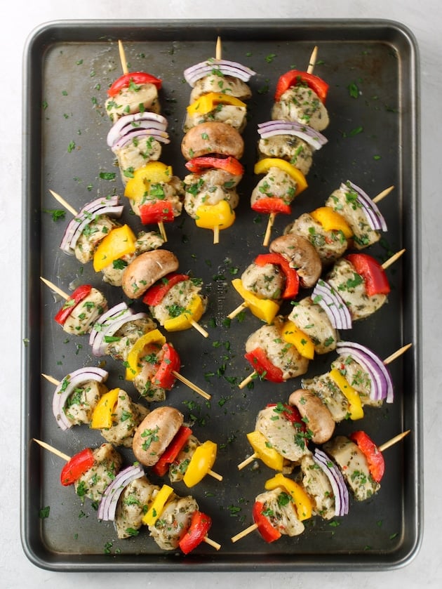 baking sheet with chicken kabobs before cooking