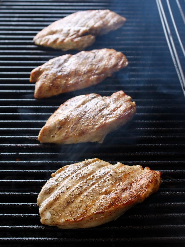 Chicken breasts grilling on grill for choripollo.