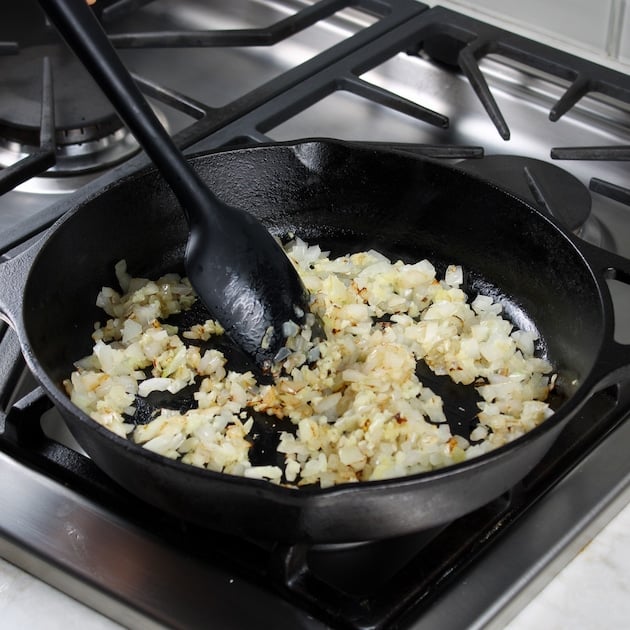 Onions sauteeing in skillet on stovetop