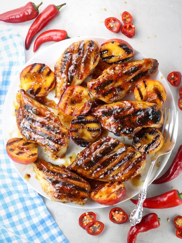Barbecue Chicken with Peach Glaze and Grilled Peaches on a platter