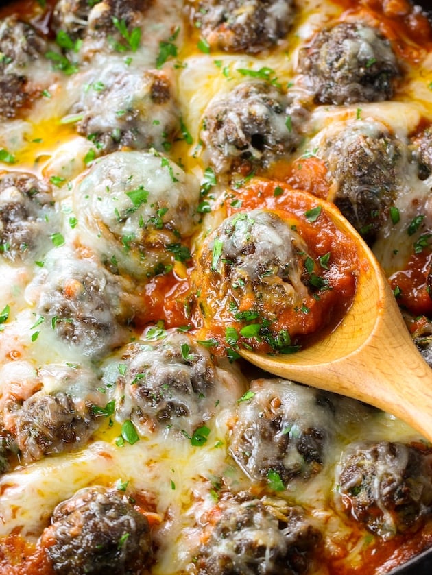 close up meatballs covered with melted cheese