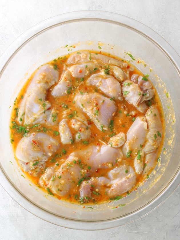 Glass bowl with chicken marinating