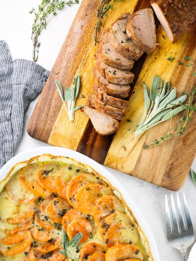 A flat lay of Smoked Cherrywood Chipotle Pork Tenderloin with Sweet Potato and Gruyere Gratin