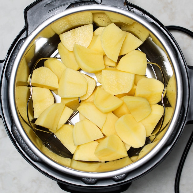 Cut up raw gold potatoes in the Instant Pot.