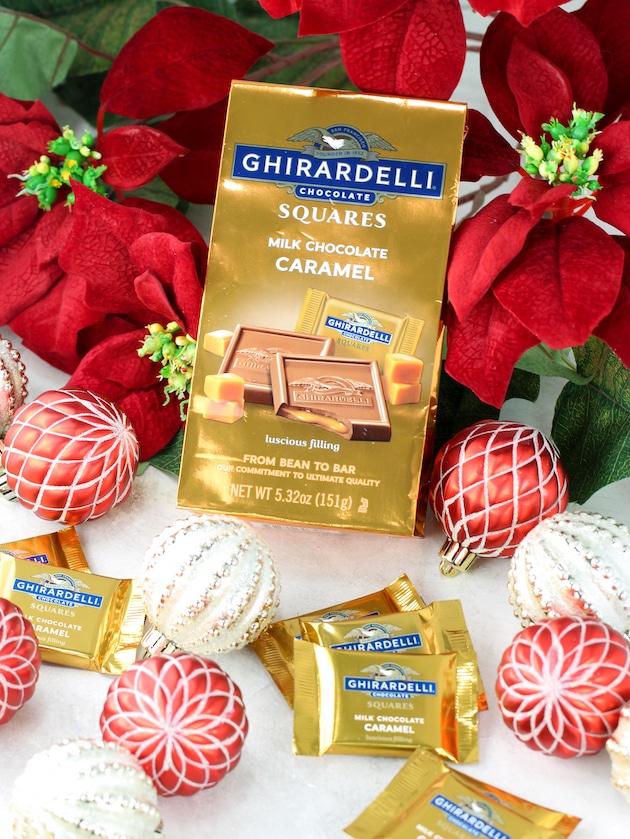 Ghirardelli Chocolate Caramel Squares with ornaments and poinsettas.