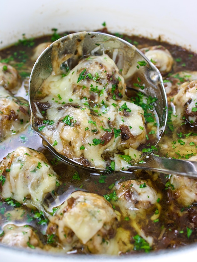 Low Carb French Onion Soup with Meatballs in a ladle in the pot.