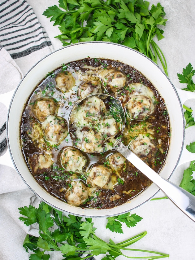 Low Carb French Onion Soup with Meatballs in a pot with a ladle with meatballs.