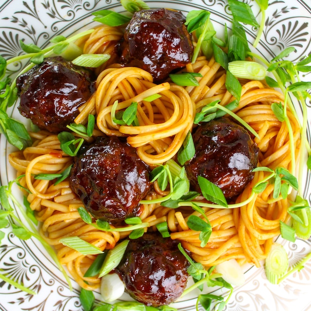A close up photo of Sweet and Tangy Asian Meatballs tossed with Asian Noodles