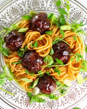 A close up photo of Sweet and Tangy Asian Meatballs tossed with Asian Noodles