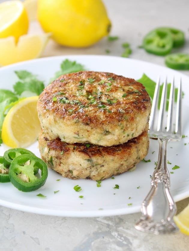 Two Tuna Patties stacked on top of each other on a plate.