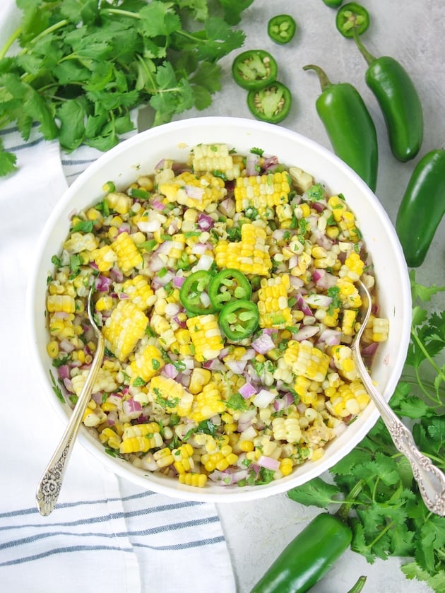 Jalapeño Cilantro Corn Salad in a serving dish with spoon dish with spoons over head