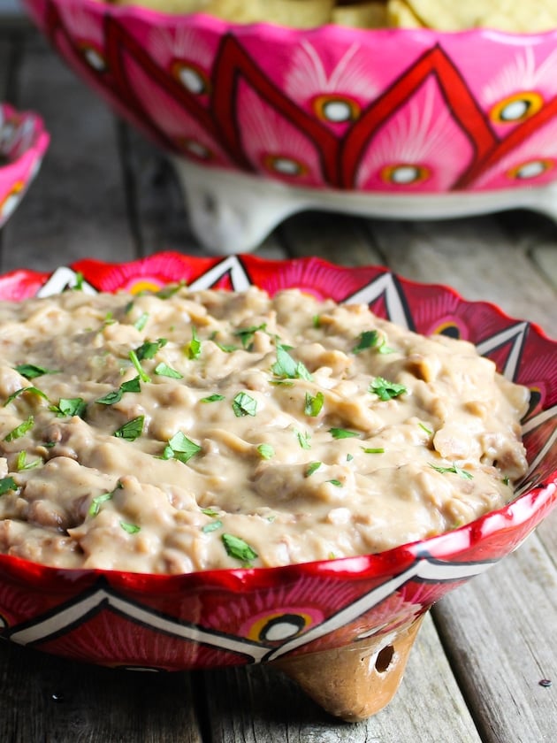 A bowl of cooked and mashed canned pinto beans.