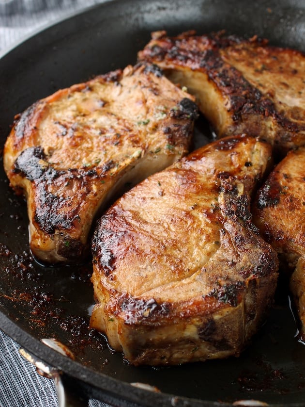 Delicious pan-seared ranch seasoned pork chops in a skillet.